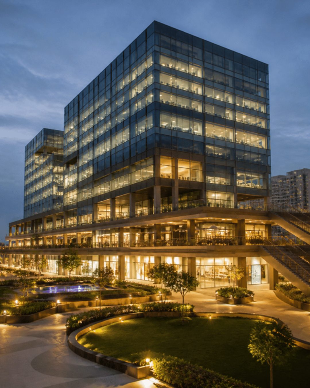 Commercial and mixed-use project marketing in Hyderabad: retail and office tower at dusk