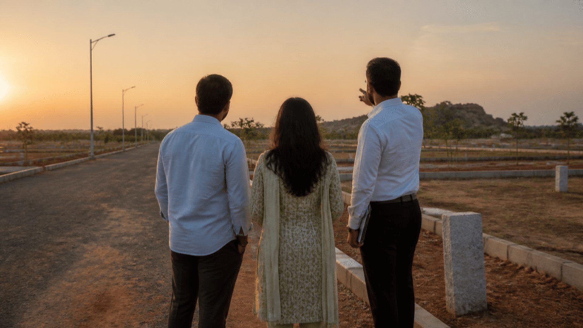 Investors inspecting plot boundary stones during a DTCP HMDA plots marketing site visit in Hyderabad